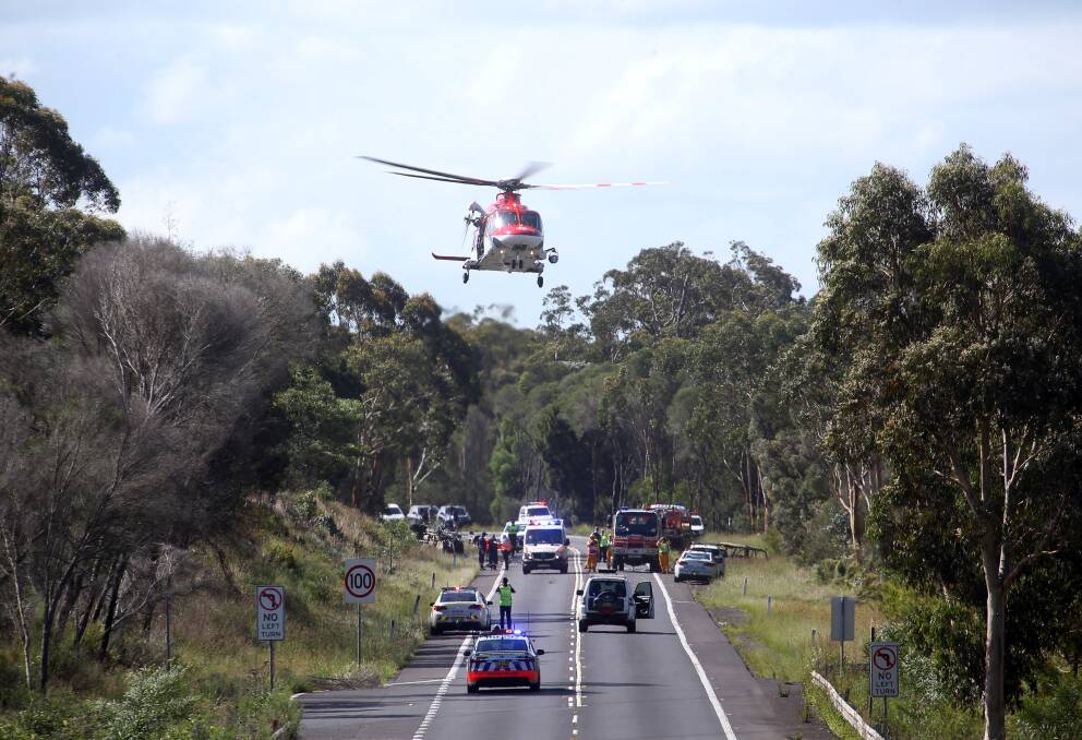 A rescue helicopter prepares to land at the scene of the fatal accident that occurred on Picton Road on Sunday afternoon. Picture: Robert Peet