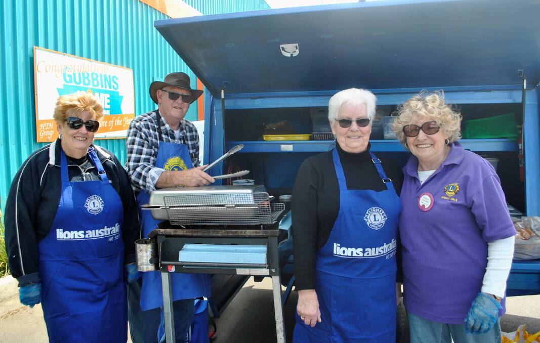 Moss Vale Lions members Jan Reeves, Charles Kennaway, May Kennaway and Marion Peisley at their weekly barbecue outside Gubbins hardware store in Moss Vale. Photo: Charli Shield. 