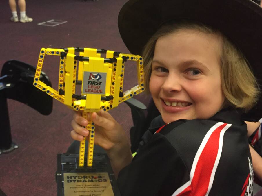 ROBOTICS: Glenquarry Public School student Cara Sims holds her team's trophy from the First Lego League's robotics competition. Photo: Supplied.