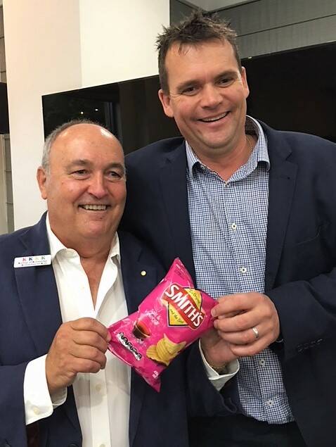 4K president Tony Springett and auctioneer Nicko Johnson hold the $3600 packet of chips. Photo: Supplied.