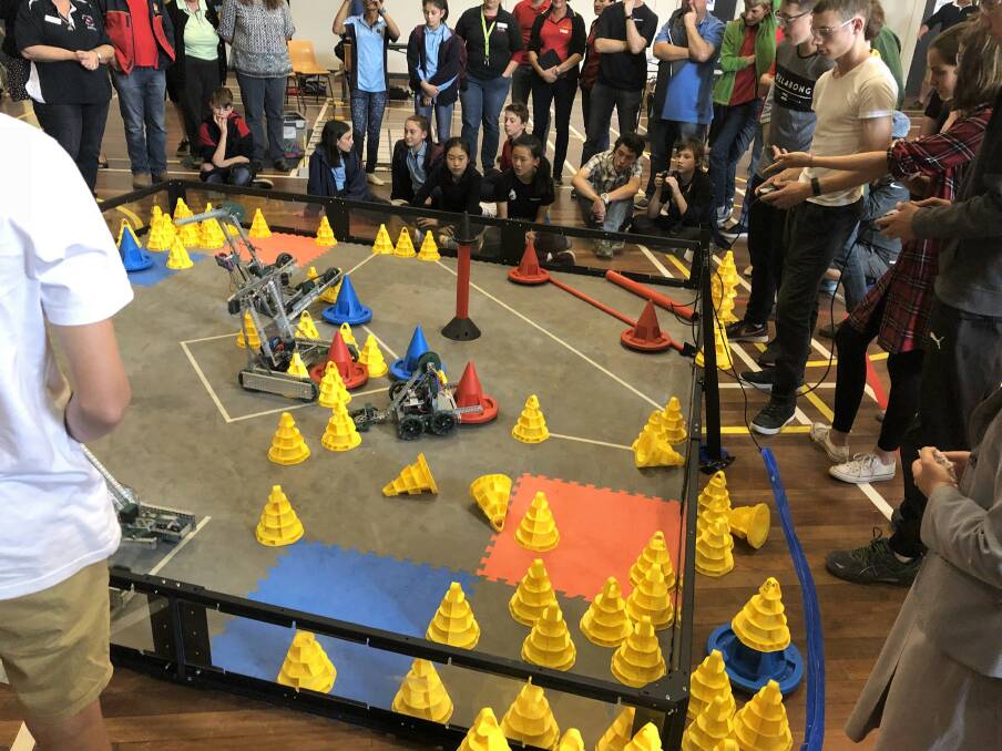 Named ‘In the Zone’, the competition was played on a square field and required students to either program or drive-control their robots to move cones around the space. Photo: Supplied. 