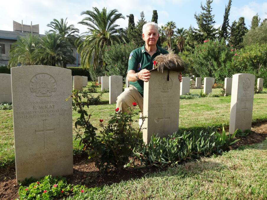 Wearing with pride: Austin Short at the grave of his grandfather, Howard Taylor, in Haifa, northern Israel. Picture: Sally Cripps.