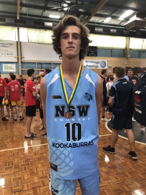 Tyler Ottosson receiving his gold medal at the Australian Country Junior Basketball Cup. His team went undefeated throughout the competition. 