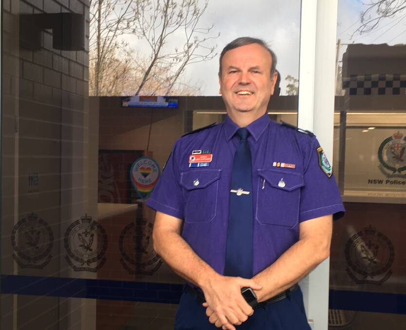 PURPLE PRIDE: Bowral Police Inspector John Klepczarek in his purple uniformed shirt and newly placed safe space for LGBTIQ community sticker.