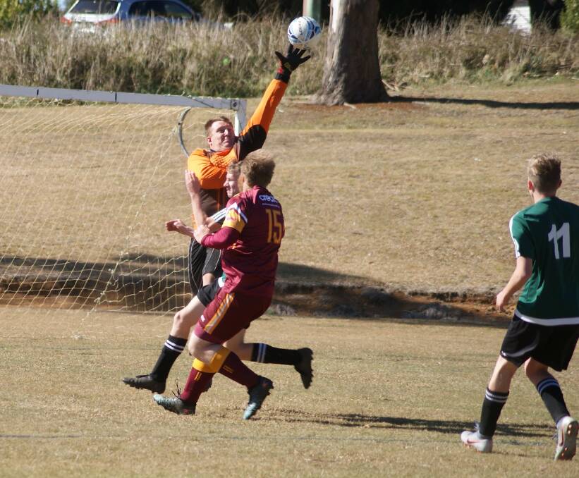 WHAT A SAVE: With a stretch and his fingertips, this goal keeper makes an outstanding save. Photo supplied by Robertson-Burrawang Rovers Soccer Club. 