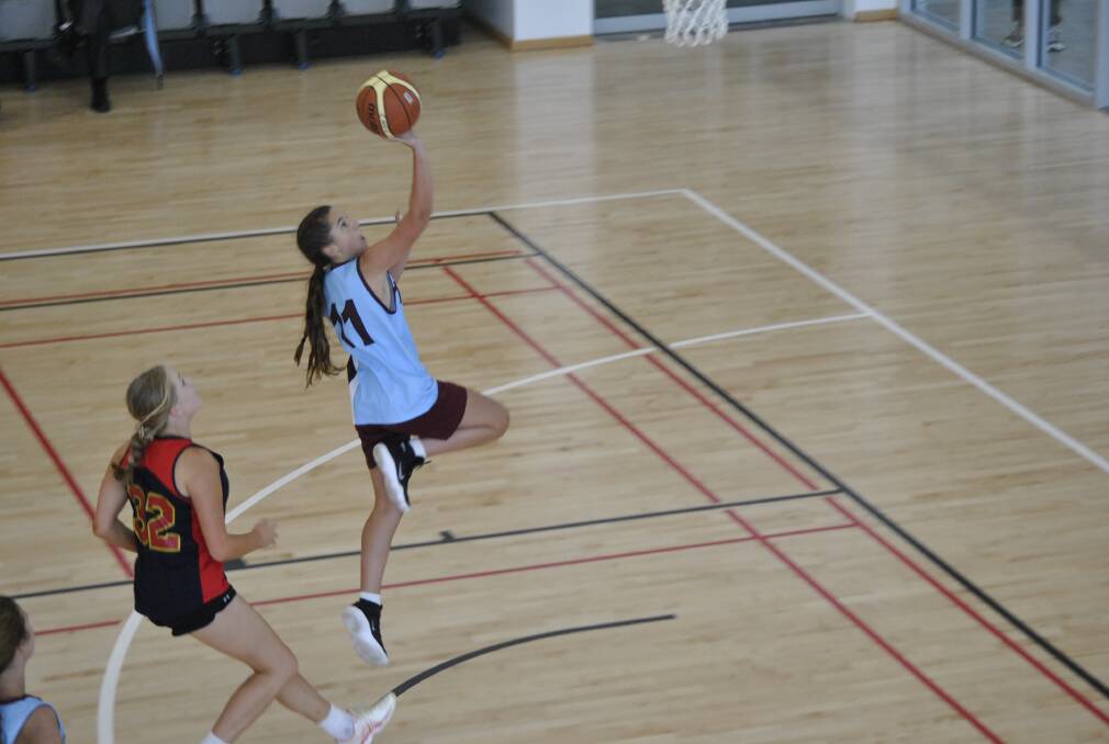 SOFT TOUCH: A beautiful floater in the key from Sophie Irvine. Sophie was Chevalier College top scorer with 12 points.
