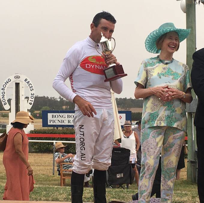 Jockey Ricky Blewitt kissing the cup with trainer Gai Waterhouse all smiles.
