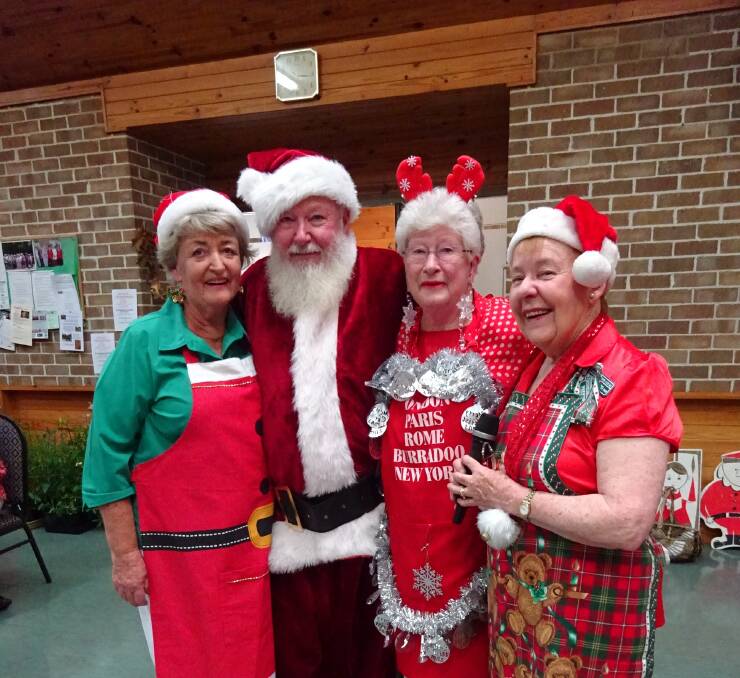Shandra Egan, Santa, Judy Keast, and Mittagong Garden Club president Nancy Wood enjoy the club Christmas party. Photo: supplied