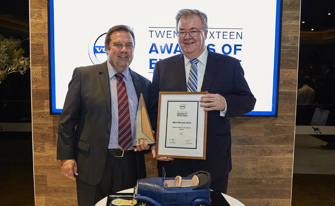 At the pinnacle: David Mackay (left) proudly steps up to take to be presented with a national award won by Mackay Volvo in Moss Vale. Photo: Supplied