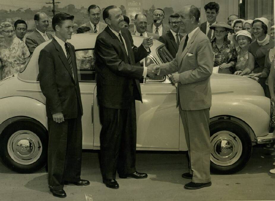 Laurie representing BMC in handover of new Morris Minor to “Pick A Box” winner with Bob Dyer the famous TV quiz master. He was 18 years old. Photo: supplied
