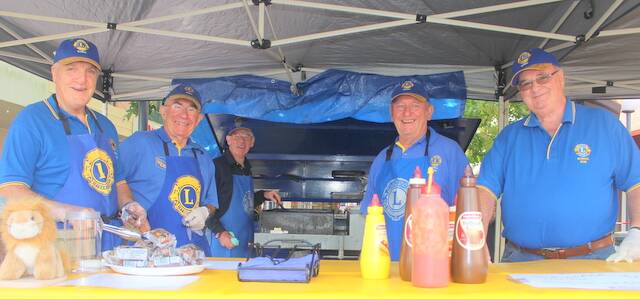 Bowral Lions Club members serving their  well-known  sausage on a roll: Graeme Moffat, Bill Bransom, Tom Dolan, Peter Upton and Bob Short. Photo: supplied 