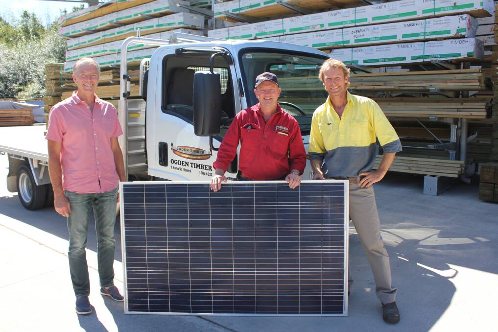 SOLAR SAVINGS: Miles Lochhead, Steve Pullbrook and Andy Lemann inspect the Repower solar system before it was installed at Ogden Timber and Hardware. Photo: supplied
