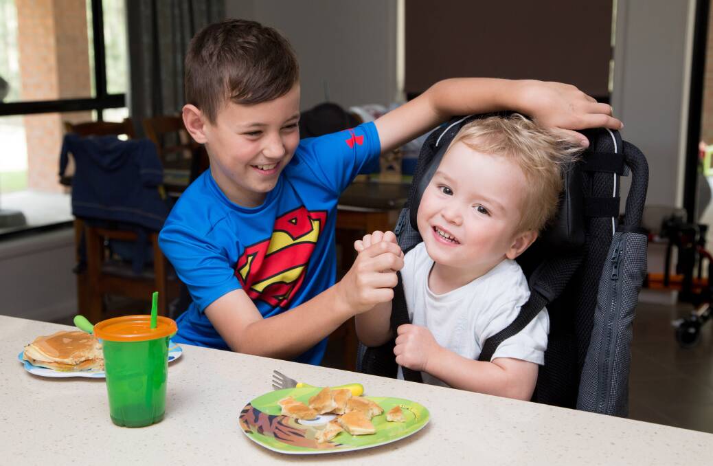 Spencer Clarke has Spastic Diplegic Cerebral Palsy and cannot walk, stand and sit without assistance. Thanks to Variety - The Children’s Charity NSW’s provision of a Lo base, Spencer can now sit comfortably at the dinner table and breakfast bar with his big brother, Connor. Photo: supplied