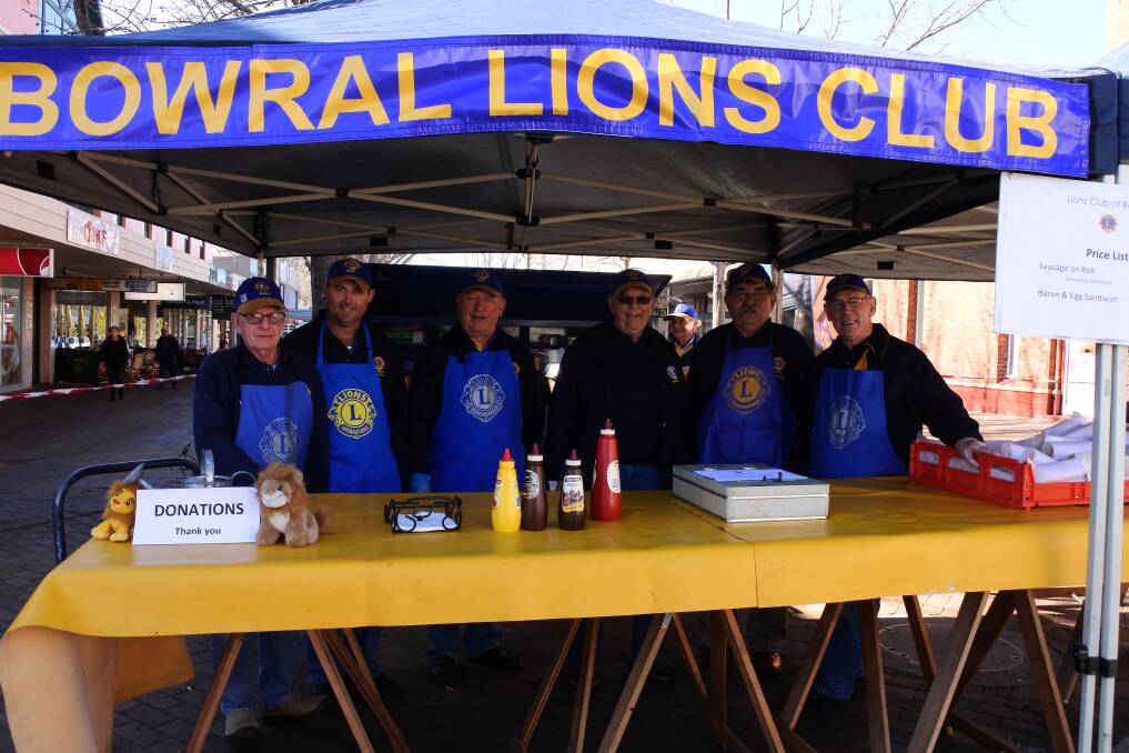 Bowral Lions Club members cooking up a storm in Corbett Plaza for Korina Valentine. Photo: Madeline Crittenden