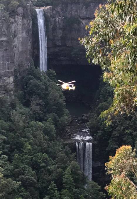 VERTICAL RESCUES: Toll chopper winching a woman to safety at Belmore Falls on April 17. 