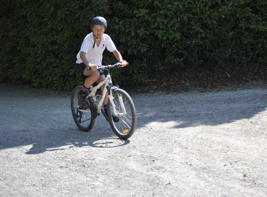 TUDOR TRIATHLON: A young athlete in action at the bike leg of the 26th Tudor House Triathlon on November 30. Photo: Madeline Crittenden. 
