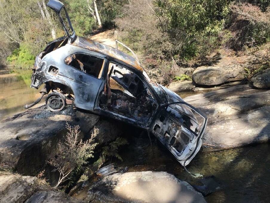 DUMPED CAR: Meryla State Forest is the latest location to be used as an illegal dumping ground, this car was found in Gunrock Creek recently. Photo: supplied. 