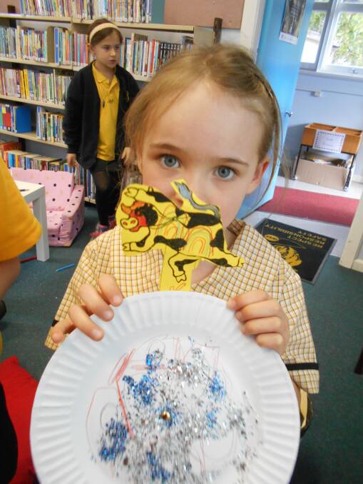 SIMULTANEOUS STORYTIME: A Wingello Public Schol student with her Cow Tripped Over the Moon creation. Photo: supplied. 