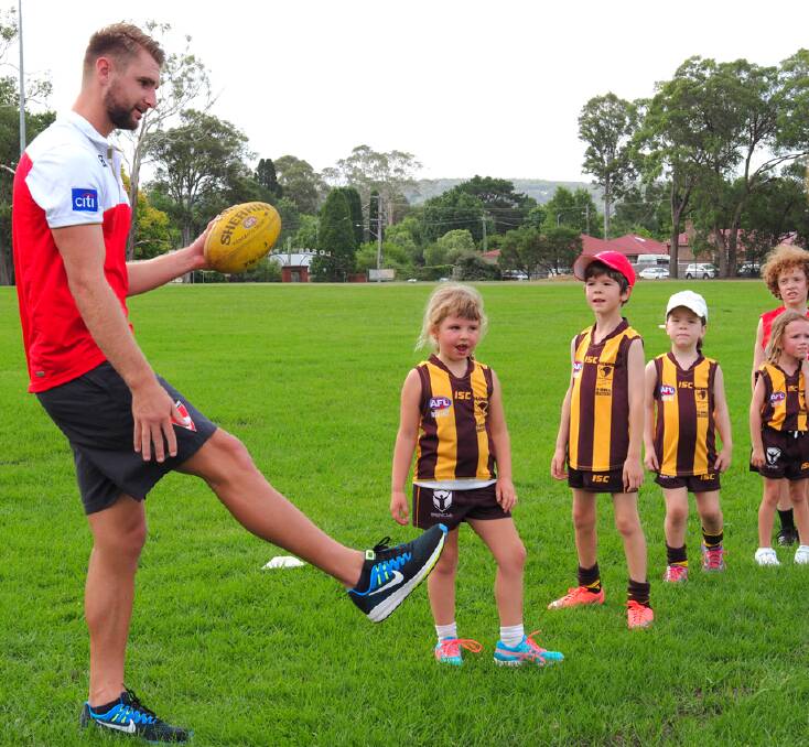HIGHLANDERS HIT THE SCG: Sydney Swans Harrison March with young Hawks players at a clinic in February. Photo: supplied. 