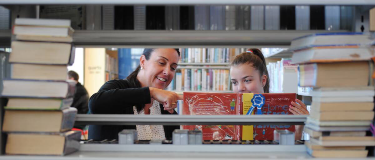 GOOD READ: Librarian Trudy Eccleston and student Anna Steward read the shortlisted book 'Go Home, Cheeky Animals!'. Photo: Emily Bennett