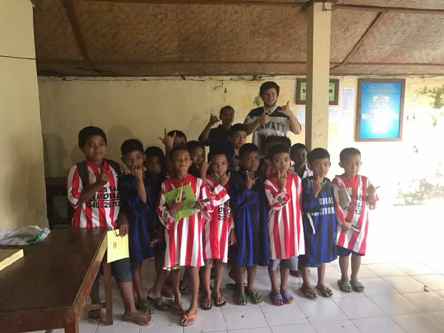 A GIFT FROM AUSTRALIA: Moss Vale Public School teacher Lisa Evans recently travelled to Bali and donated shirts from Moss Vale Soccer Club. Photo: Contributed