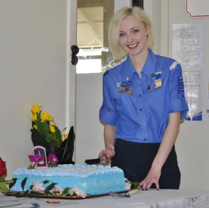 ACCOMPLISHED: Queen's Guide Award recipient Maddy Saffery cut a celebratory cake at Mittagong Guide Hall. Ms Saffery will receive her award from the governor of New South Wales next week. Photo: Emily Bennett