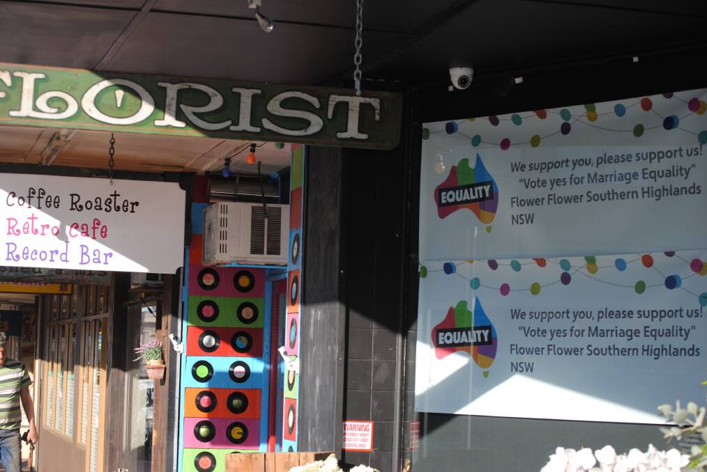 GROWING EQUALITY: Flower Flower principal designer Sarah Johanson has put up a sign in the shop window with a message for Highlanders to vote yes for equality in the Australian marriage law postal survey. Photo: Emily Bennett