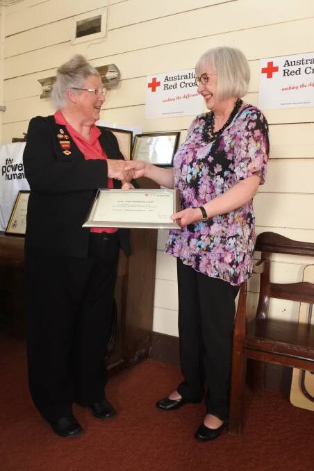 DUE REWARD: Anna Hopkins from the Exeter branch of the Red Cross received the award from Red Cross member Ann Roca. Photo: Emily Bennett