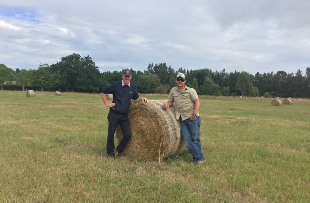 HELPING HAND: Bowral Co-Op produce manager Paul Costigan with Harby Farm manager Shane Hill with hay that will be donated to farmers in need. Photo: Contributed
