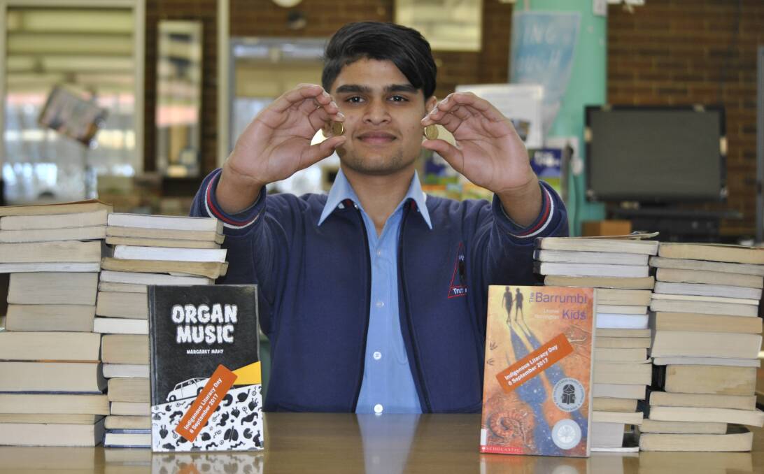 BOOKS FOR A CAUSE: Moss Vale High School year 11 student Apil Chaulagain purchased books to support International Indigenous Literacy Day. Photo: Emily Bennett