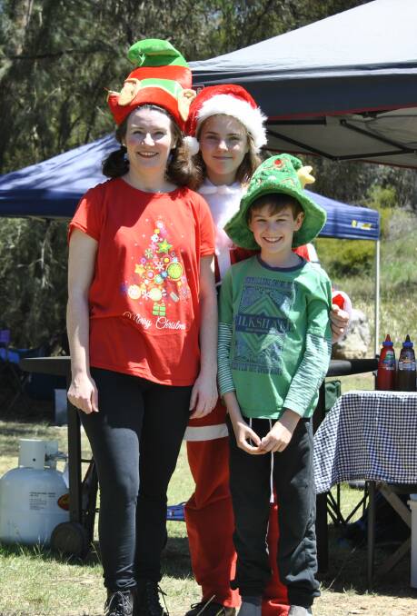 CHRISTMAS CHEER: Club members Shanna Matthews, Amelia Kelly and Isaac Matthews dressed up in their festive best for the final Spring Series meet on Sunday.