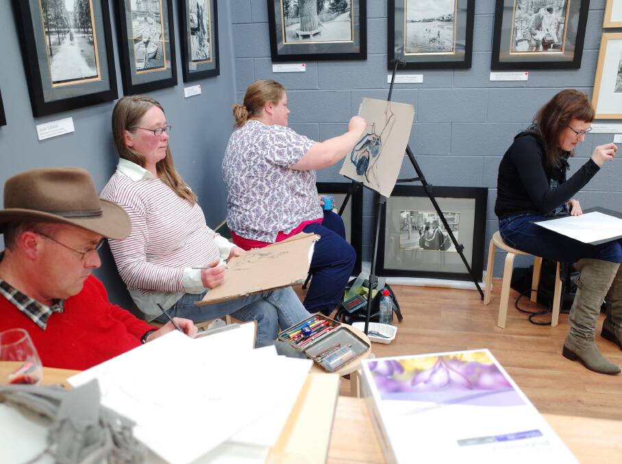 Artists at the first Drink and Draw life drawing session in Ten Thousand Paces Gallery. Photo: Hamish Ta-mé
