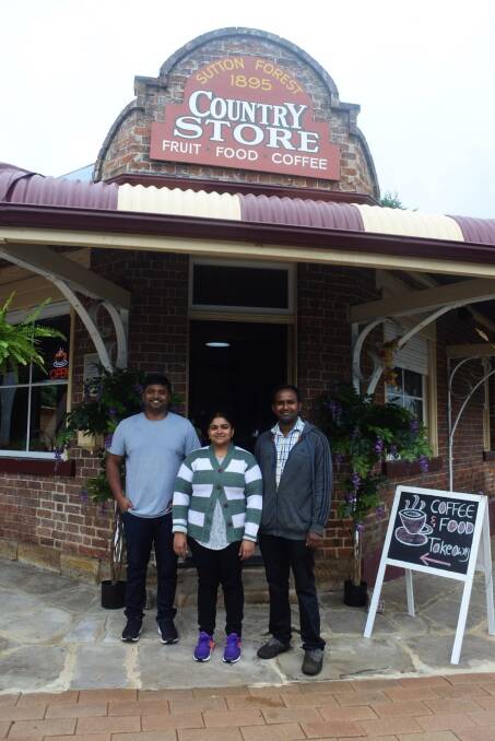 Stop and smell the coffee: Barista Sujan Valli with owners Jaya and Kish Kondapalli out the front of the newly opened Sutton Forest Country Store. Photo: Claire Fenwicke