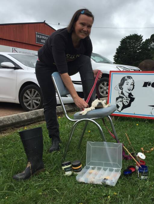 Getting glammed up: Rockabellas Cafe owner Ellie Di Bella preparing her gumboots for the competition. Photo: Claire Fenwicke