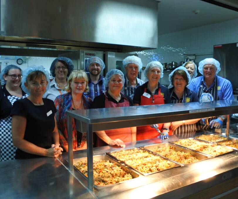 Cooking up a storm: Harbison Care Burradoo staff and Rotary Bowral-Mittagong members cooked for three hours to give residents a special treat. Photo: Claire Fenwicke