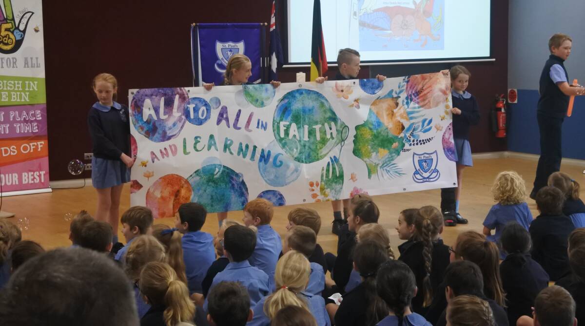 New beginning: St Paul's Primary School leaders revealing the school's new vision at a special assembly on March 9. Photo: Claire Fenwicke