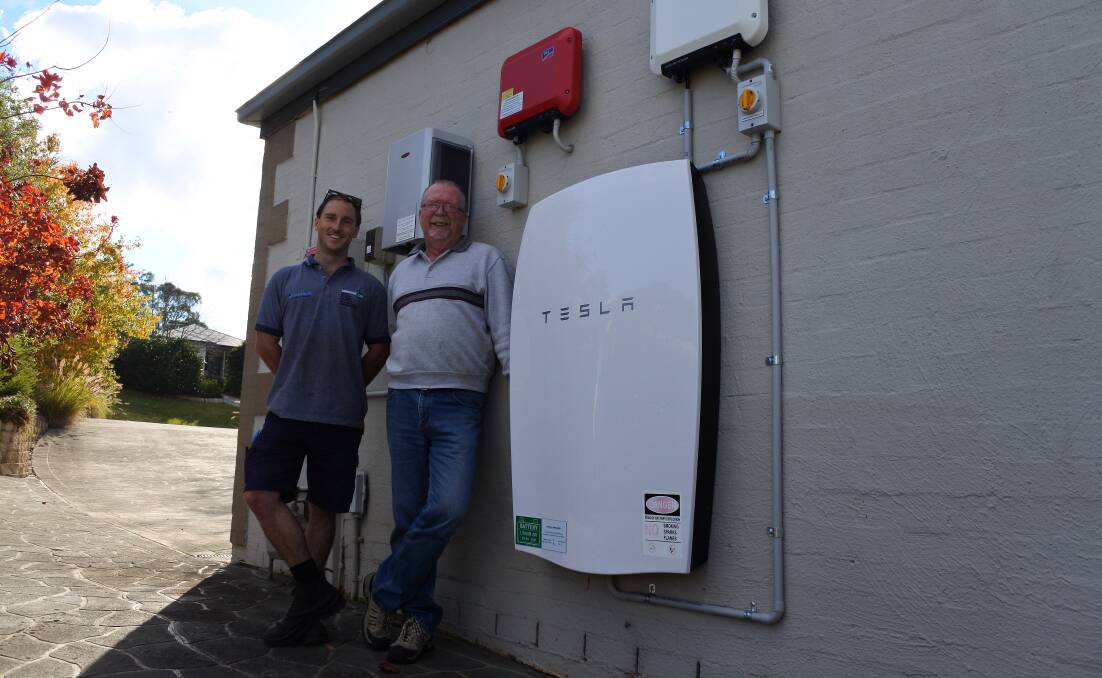 Future of energy: Simmark branch manager Henry de Wilde and East Bowral's Allan Reid with the Tesla solar battery. Photo: Claire Fenwicke