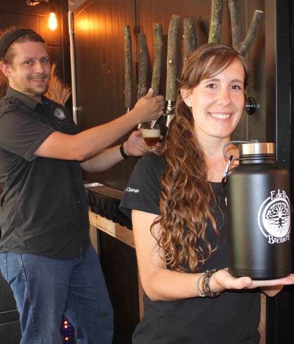Crafted with care: Eden Brewery's Jacob Newman pours a beer, while Deb Newman shows off one of the growlers available for purchase. Photo: Claire Fenwicke