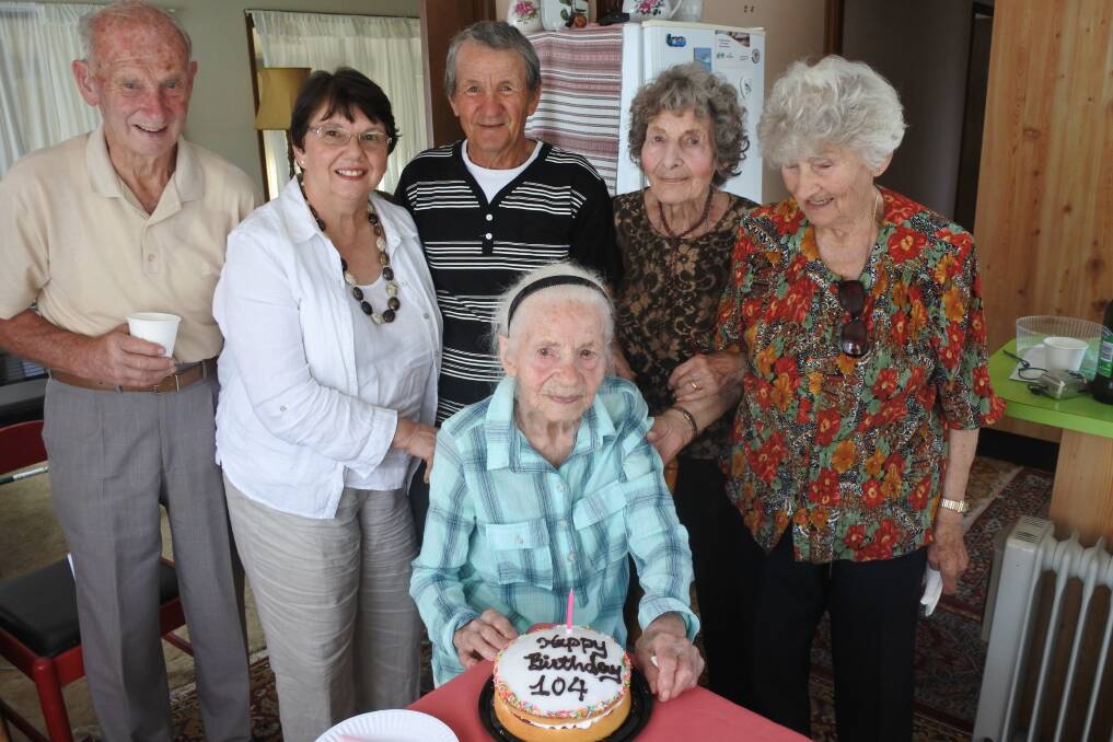 Happy birthday: Elizabeth Szilagyi (seated) surrounded by her neighbours and friends on her 104th birthday. Photo: Claire Fenwicke