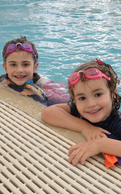 Water girls: At Moss Vale Aquatic Centre, Josephine (5) was collecting toys from the bottom of the pool, while Clemintine (4) practiced holding her breath underwater.