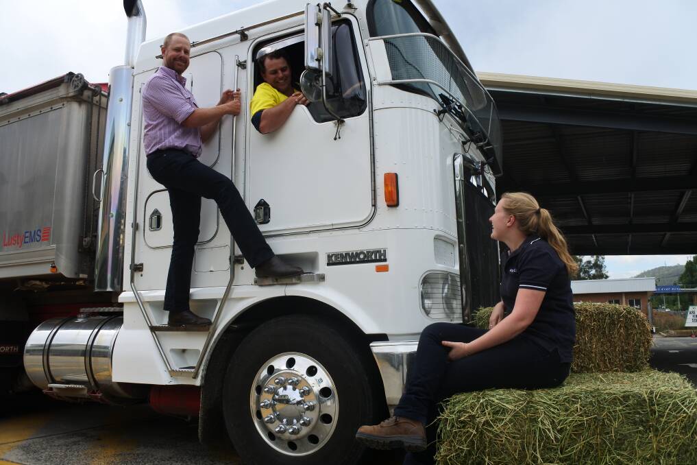 Bowral co-op produce manager Ben Crockford and manager of farm services Cara Metcalf with Burrumbuttock Hay Run truck driver Jacob Rofe. Photo: Claire Fenwicke