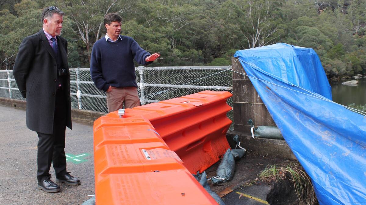 Surveying the impact: Federal Member for Hume Angus Taylor inspecting the damaged Broughton Pass Bridge recently with Wollondilly Shire Council director of infrastructure and environment, Michael Malone. Photo: supplied