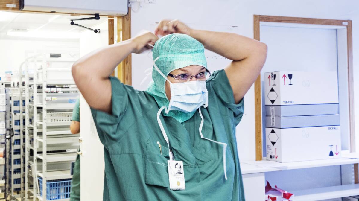 A surgical nurse prepares to head into surgery. Photo: FDC