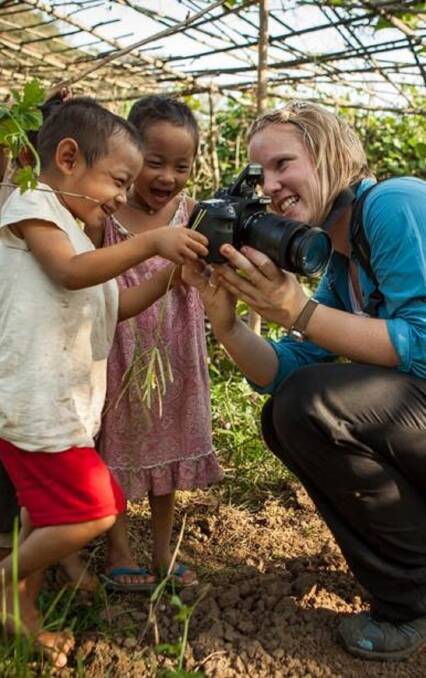 HANDS-ON: Karen with some children in a refugee camp in Burma. (Top) Karen McGrath and Ben Littlejohn with refugees in a Jordan camp. Photos: supplied
