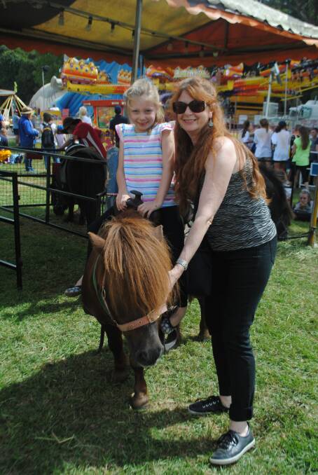 Connecting with the country: Kerri Donaldson with Sienna Wimborne enjoying a miniature pony ride at the 2016 Robertson Show. Photo: file