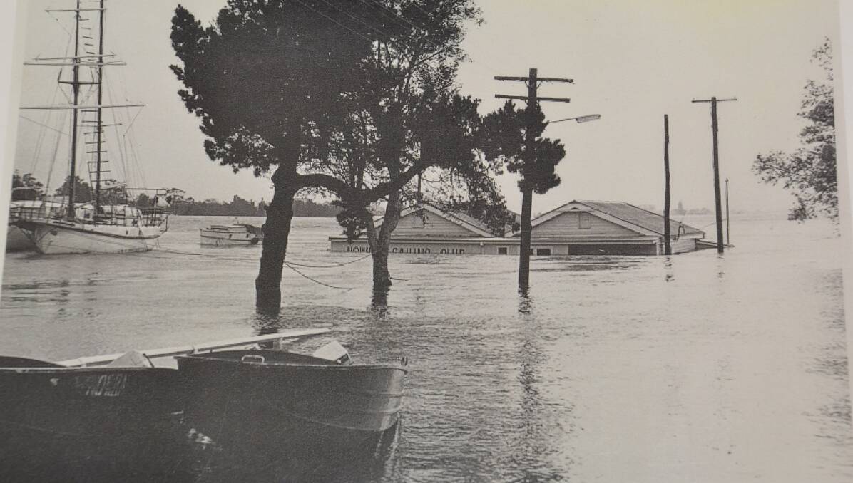 FLOOD MEASURE: The former Nowra Sailing Club building has been used as the town's unofficial flood record for years. This is the 1974 flood. Photo: Shoalhaven Historical Society.
