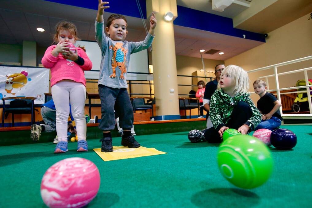 CHILD'S PLAY: Sierra Knightly,4, and Adam Reid, 3, play indoor bowls for the launch of the 10th annual Kidsfest Shellharbour, Friday in Barrack Heights. Picture: Adam McLean