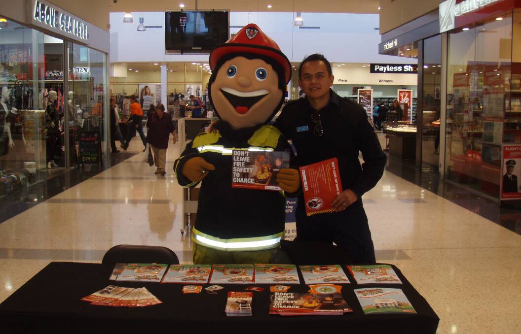 Have a chat with your firies: Highlands firefighters will be at Highlands Marketplace on May 20, and Bundanoon, Mittagong and Moss Vale stations will open their doors for an open day. Pictured: Chris Cruz and FRNSW mascot Bernie Cinders. Photo: supplied