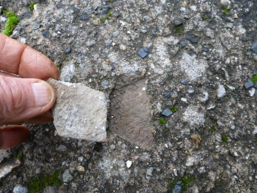 A cement fragment suspected of containing asbestos found on McEvilly Road, Robertson in 2013. Photo: SHN