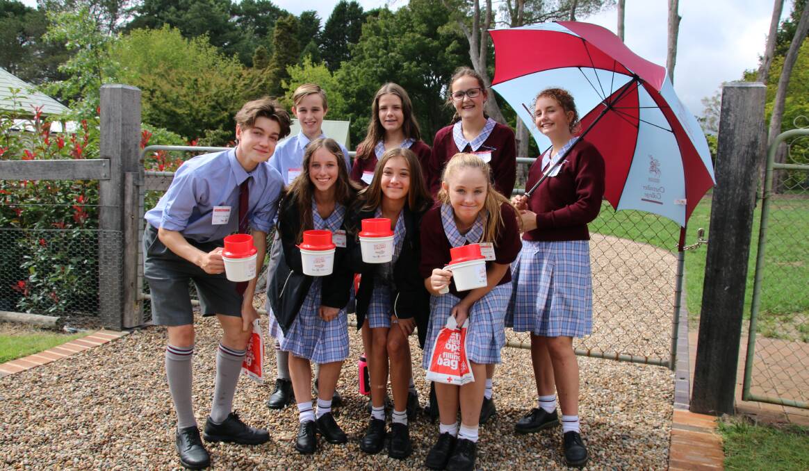 Counting on change: More than 40 students from Chevalier College volunteered to collect donations from the Burradoo region for the Red Cross Calling. Photo: Victoria Lee